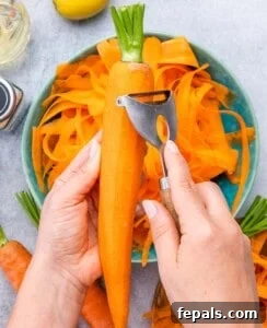Peeling a carrot into a blue bowl.