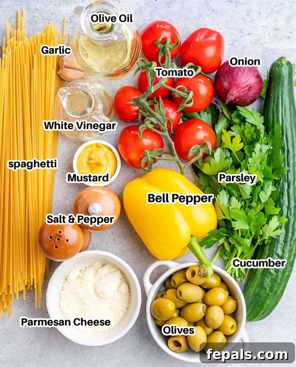Refreshing Spaghetti Salad 3 A flat lay arrangement of fresh, vibrant ingredients neatly labeled for making a delicious spaghetti salad, including pasta, assorted vegetables, and dressing components.