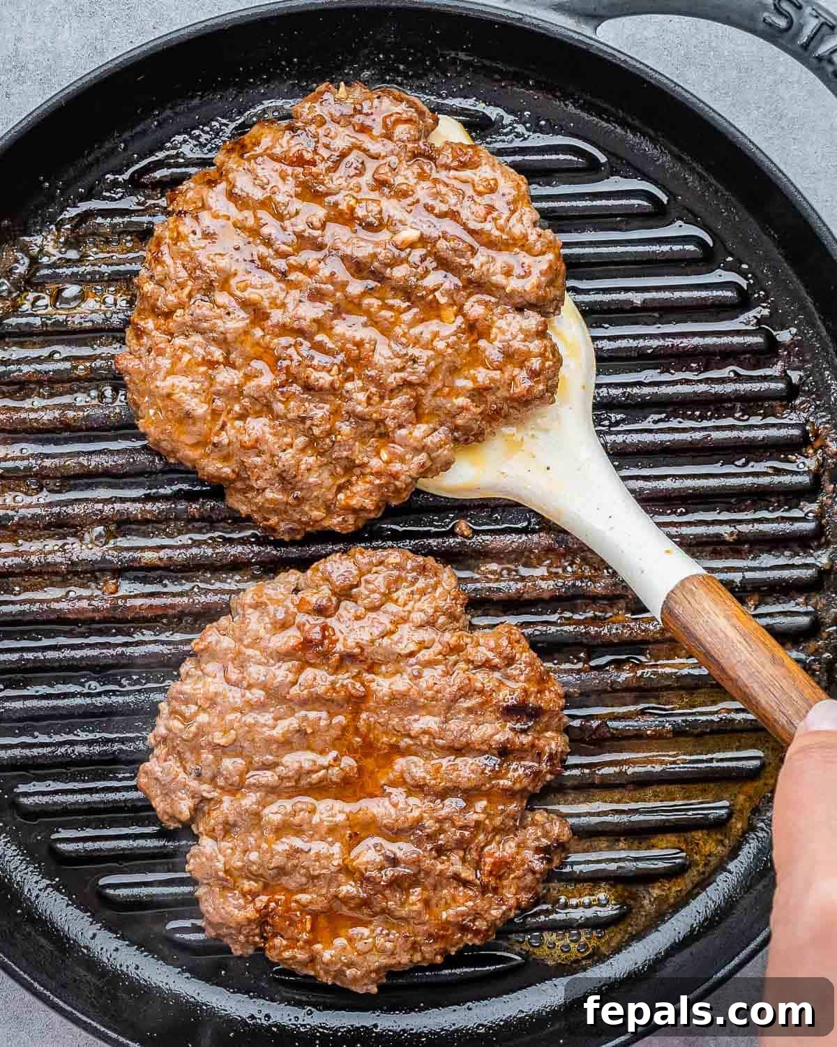 Burger Perfection, Made Easy 6 Flipping burger patties on a grill pan.