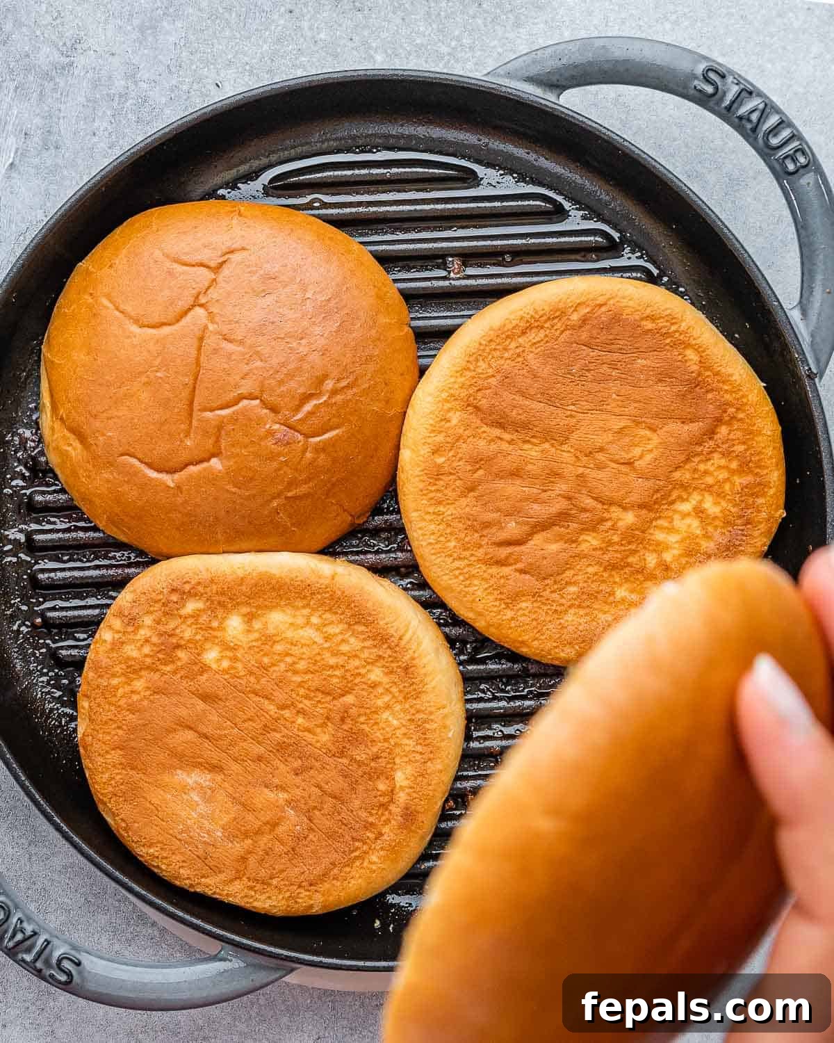 Burger Perfection, Made Easy 7 Toasting hamburger buns on a grill pan.