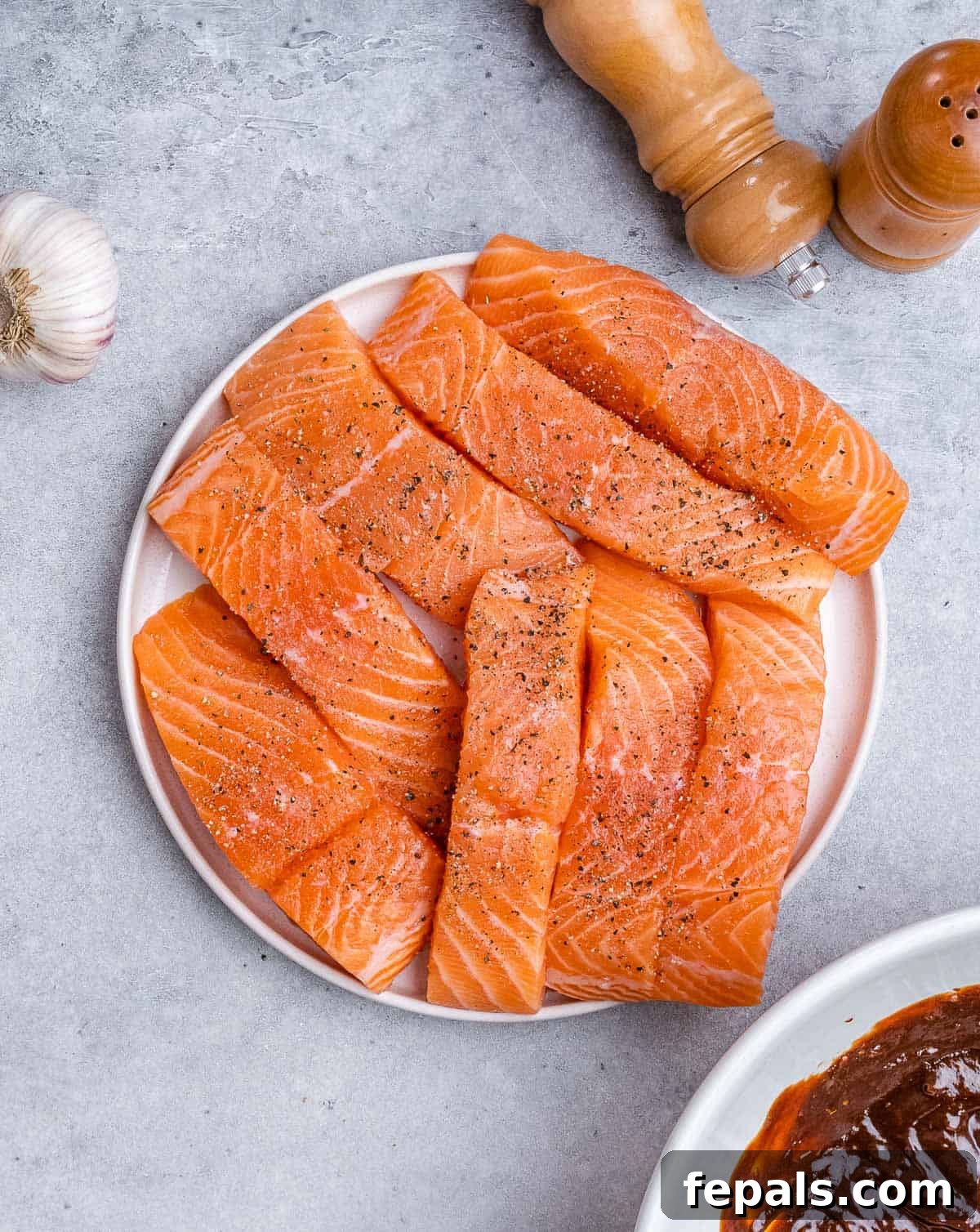 Raw salmon filets on a plate.