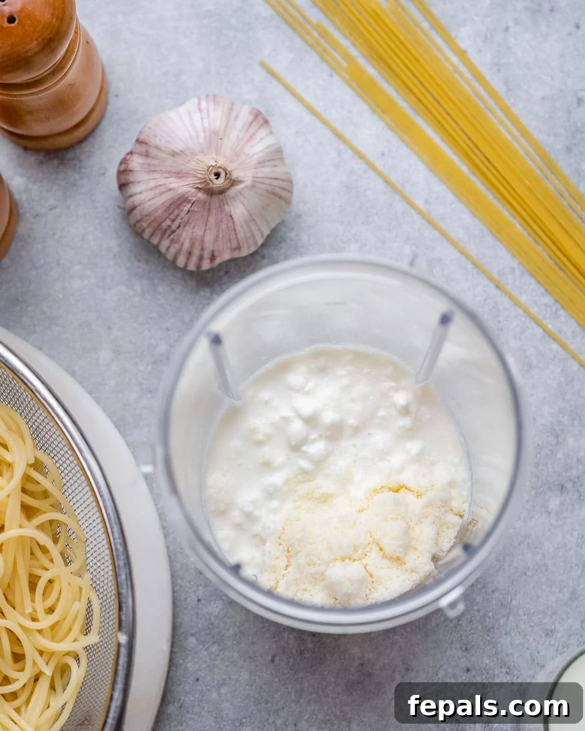 Velvety Cottage Cheese Alfredo 5 Cottage cheese, milk, and parmesan added to a blender, ready to be blended into a smooth sauce.