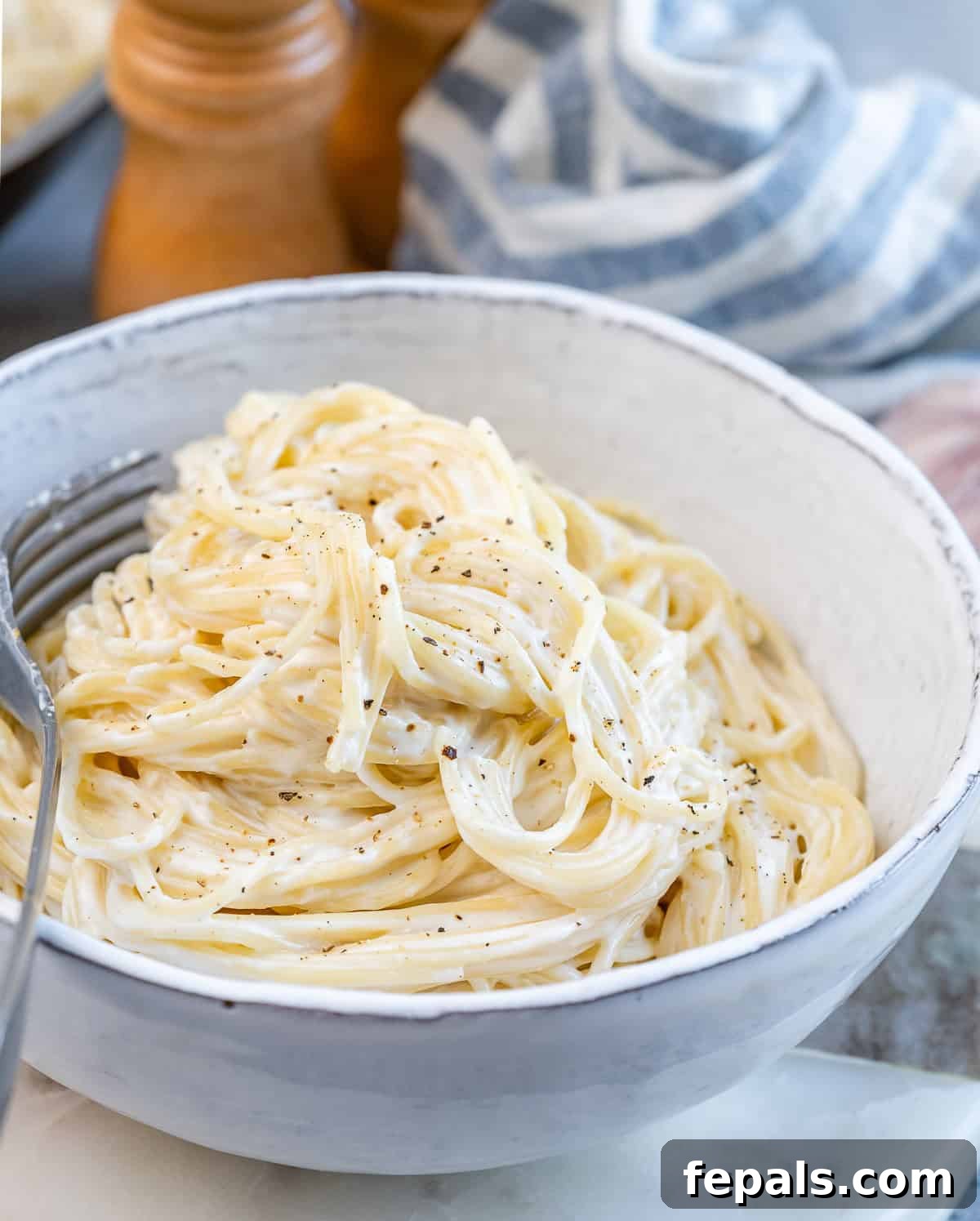 Velvety Cottage Cheese Alfredo 9 Side angle of a bowl of Alfredo pasta, with sauce visibly coating the noodles evenly.