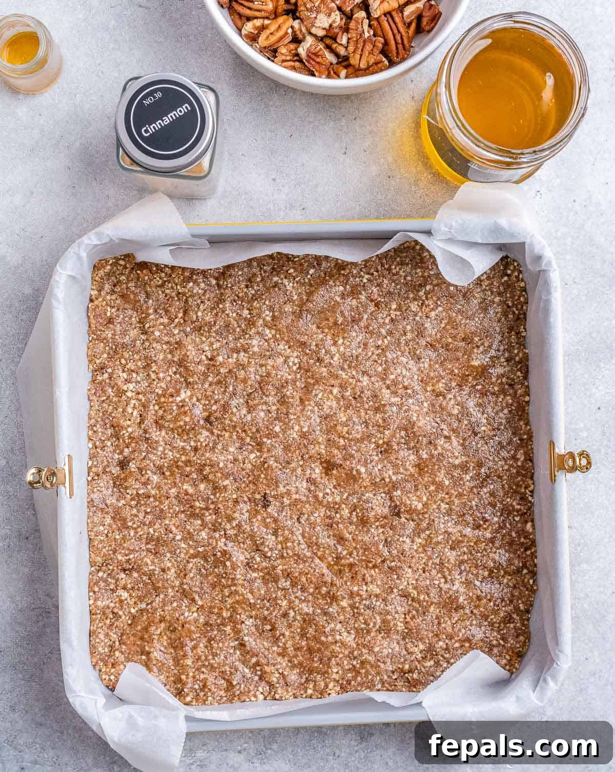 Almond flour crust pressed into a square pan.