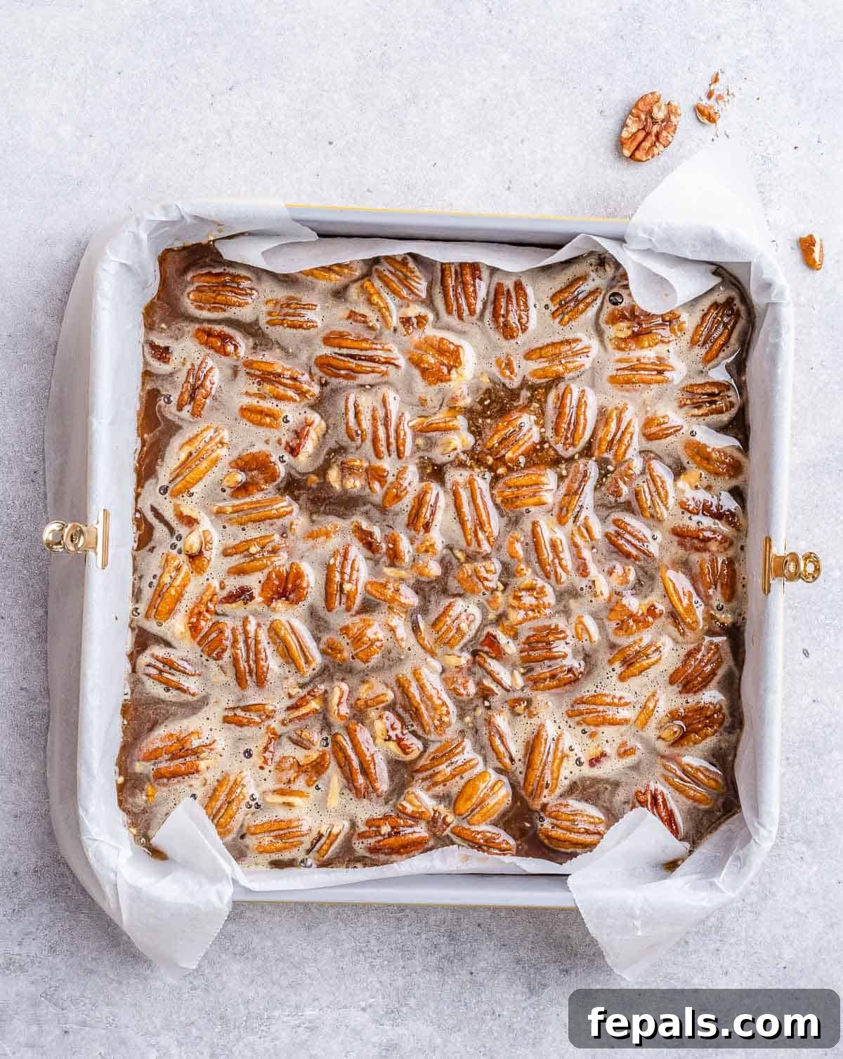 Pecan pie bars in a square pan.