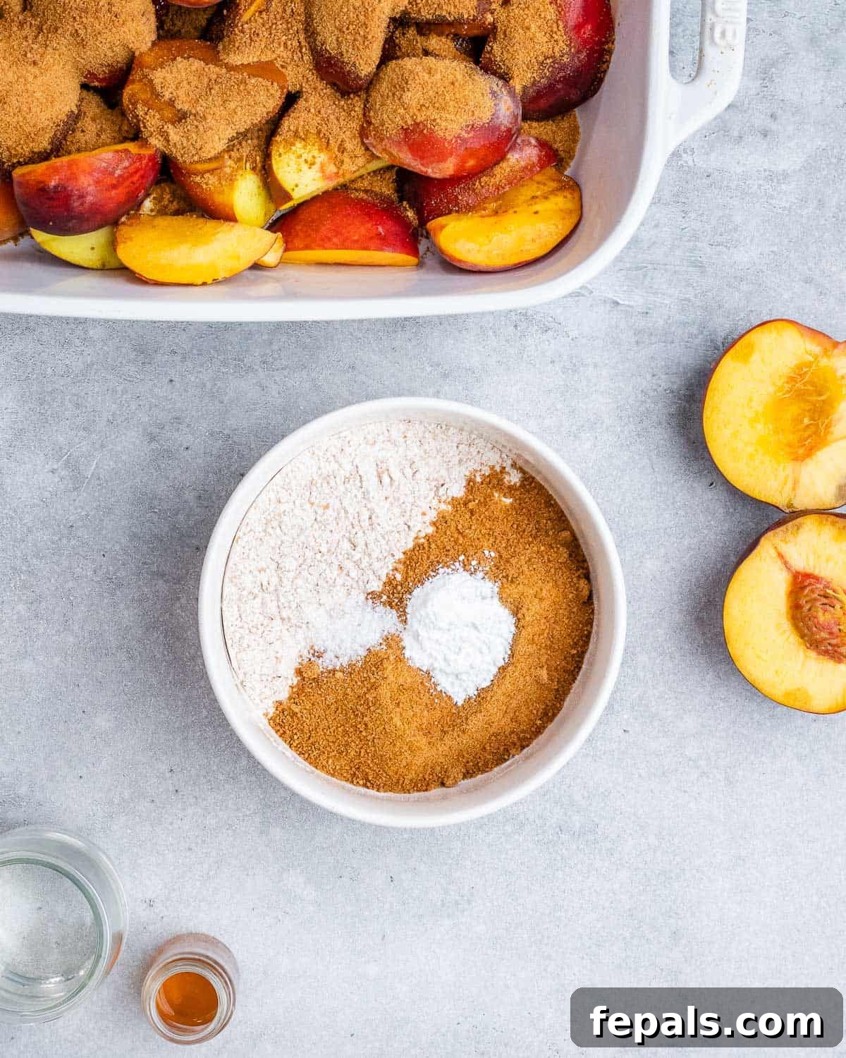 Wholesome Peach Cobbler 5 Mixing coconut sugar with flour in a small white bowl near peaches.