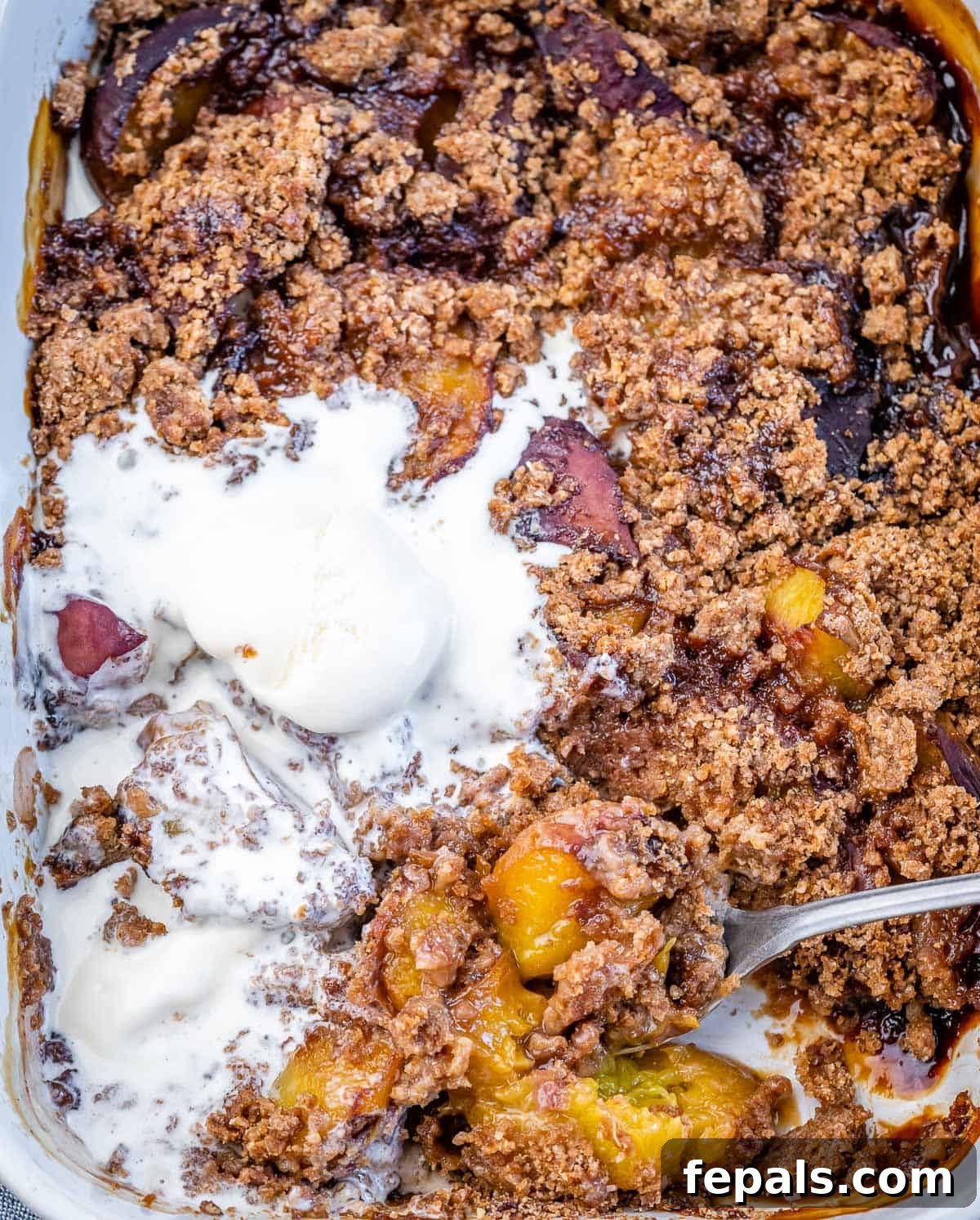 Wholesome Peach Cobbler 7 Serving peach cobbler that is topped with melting vanilla ice cream.
