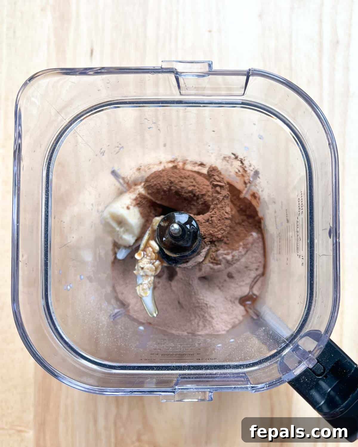 Decadent Chocolate Protein Baked Oats 4 All ingredients for baked oats, except chocolate chips, are added to a high-powered blender, ready for blending.