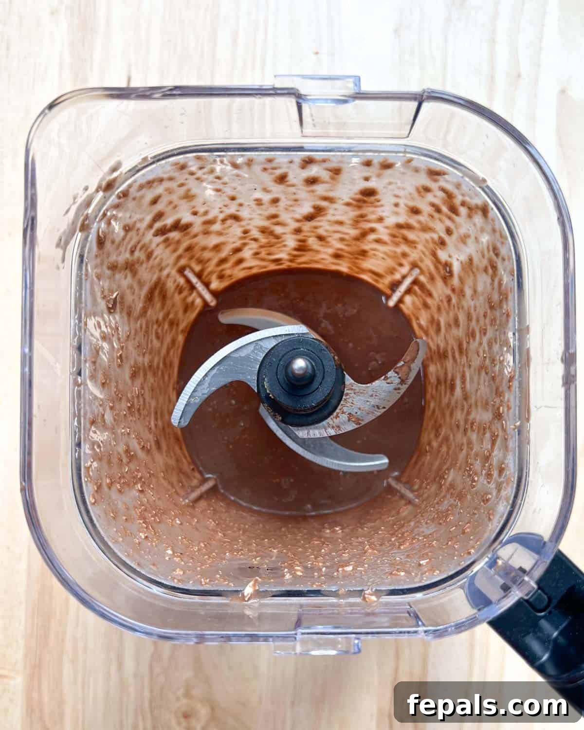 Decadent Chocolate Protein Baked Oats 5 The baked oats ingredients are fully blended into a smooth, thick batter inside the blender jar.
