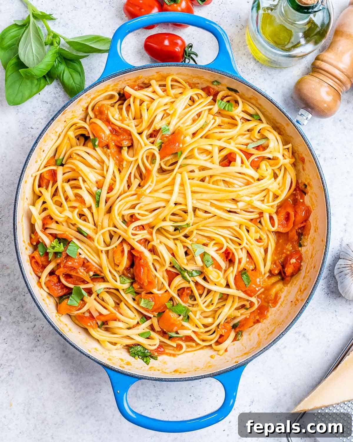 Fresh and Fast Tomato Basil Pasta 2 Cooked spaghetti in a strainer just after boiling, being lifted with tongs.