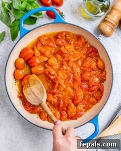 Fresh and Fast Tomato Basil Pasta 12 Cherry tomatoes bursting in olive oil in skillet.