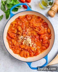 Fresh and Fast Tomato Basil Pasta 13 Smashed cherry tomatoes with garlic and parmesan in pan.