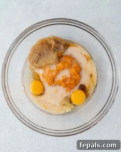 wet ingredients for sweet potato muffins added into a bowl.
