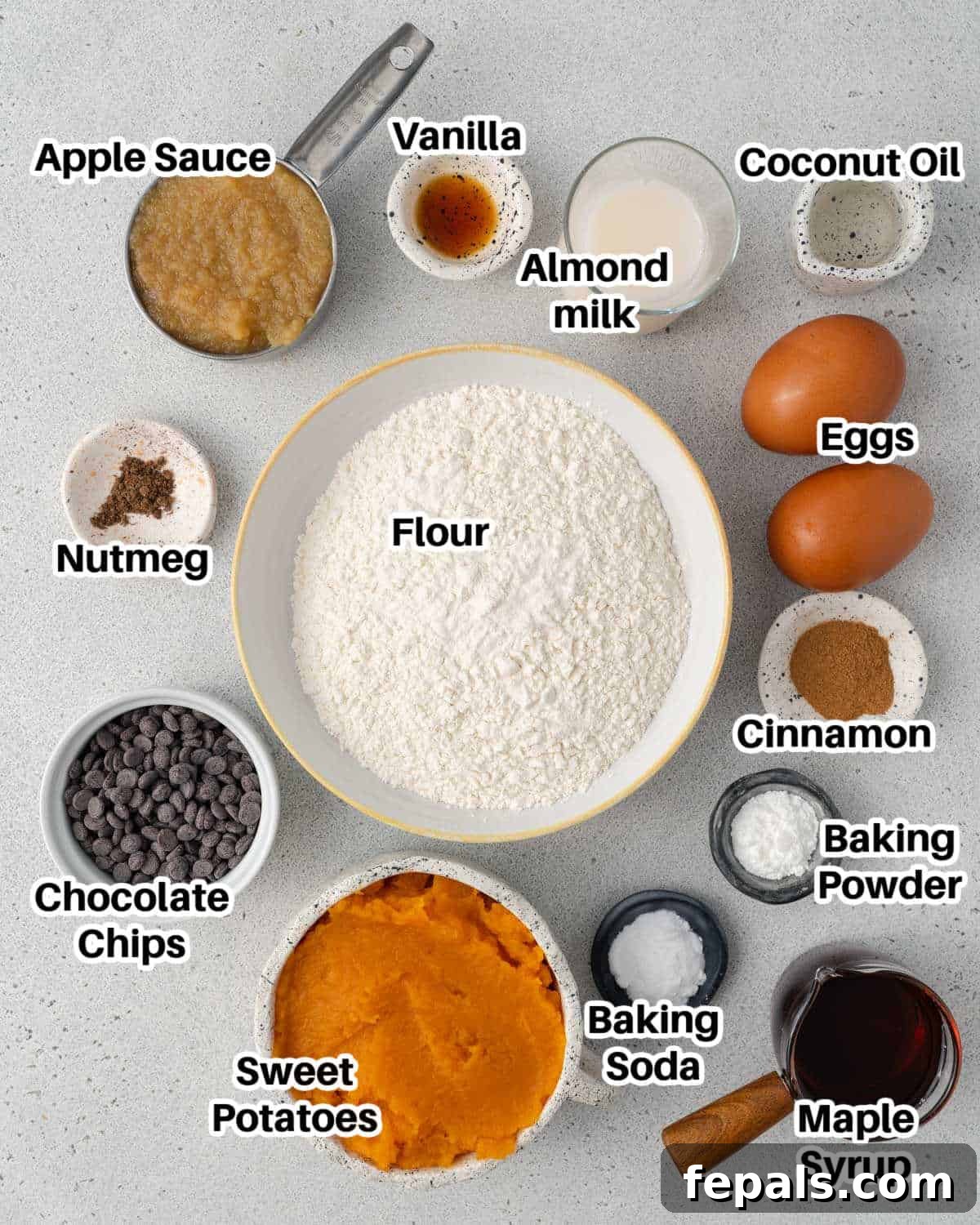 various ingredients laid out on a kitchen counter for making sweet potato muffins