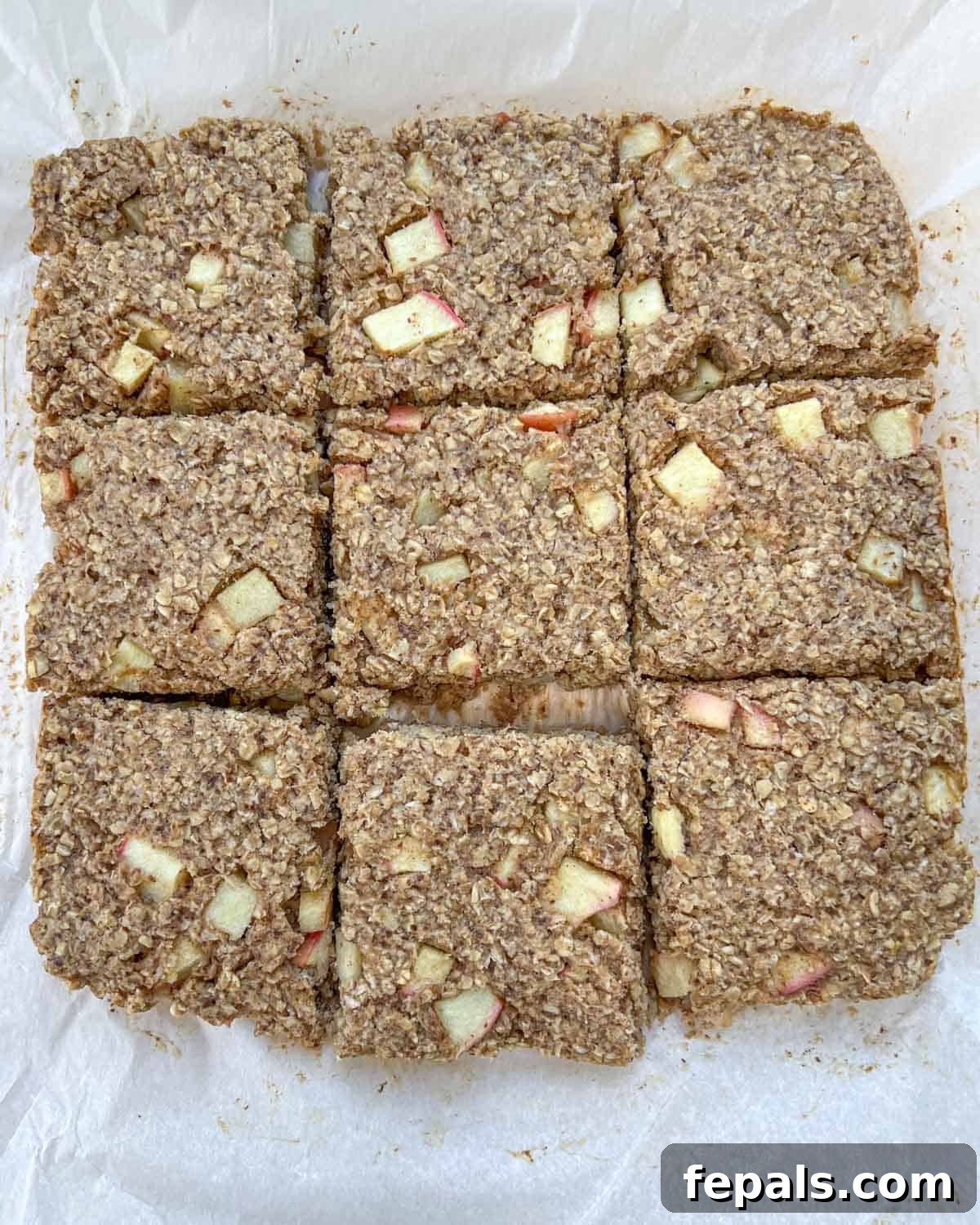 Cozy Apple Oat Squares 2 Delicious baked oatmeal bars with apples, cut into neat squares, ready to be served.