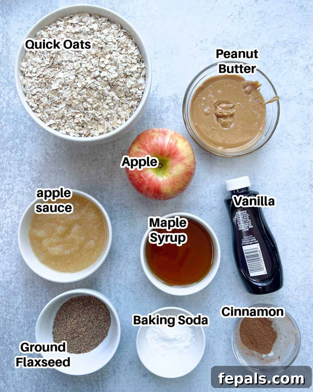 Cozy Apple Oat Squares 3 A beautiful flat lay of all the fresh ingredients needed to make homemade apple oatmeal bars, including oats, apples, spices, and wet ingredients.