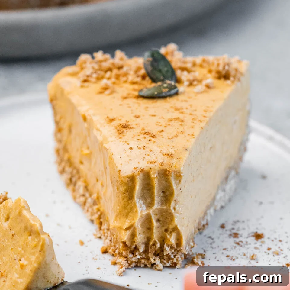 Fork taking a bit off a pumpkin pie slice.