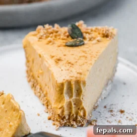 Fork taking a bit off a pumpkin pie slice.