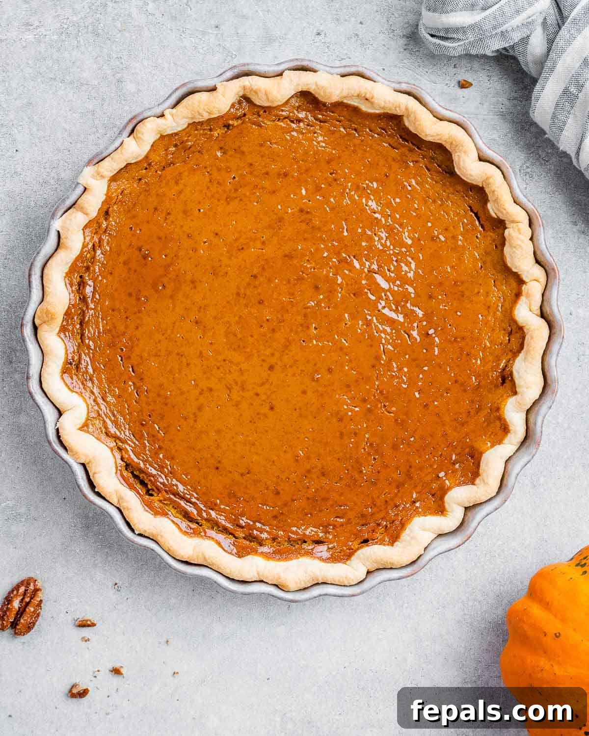 Wholesome Pumpkin Pie 7 A perfectly baked healthy pumpkin pie, golden brown around the edges, cooling on a wire rack.