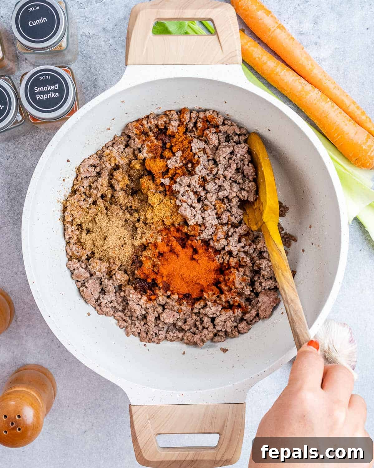 Easy Crockpot Chili 4 Browning lean ground beef with salt, pepper, and chili seasonings in a large skillet.