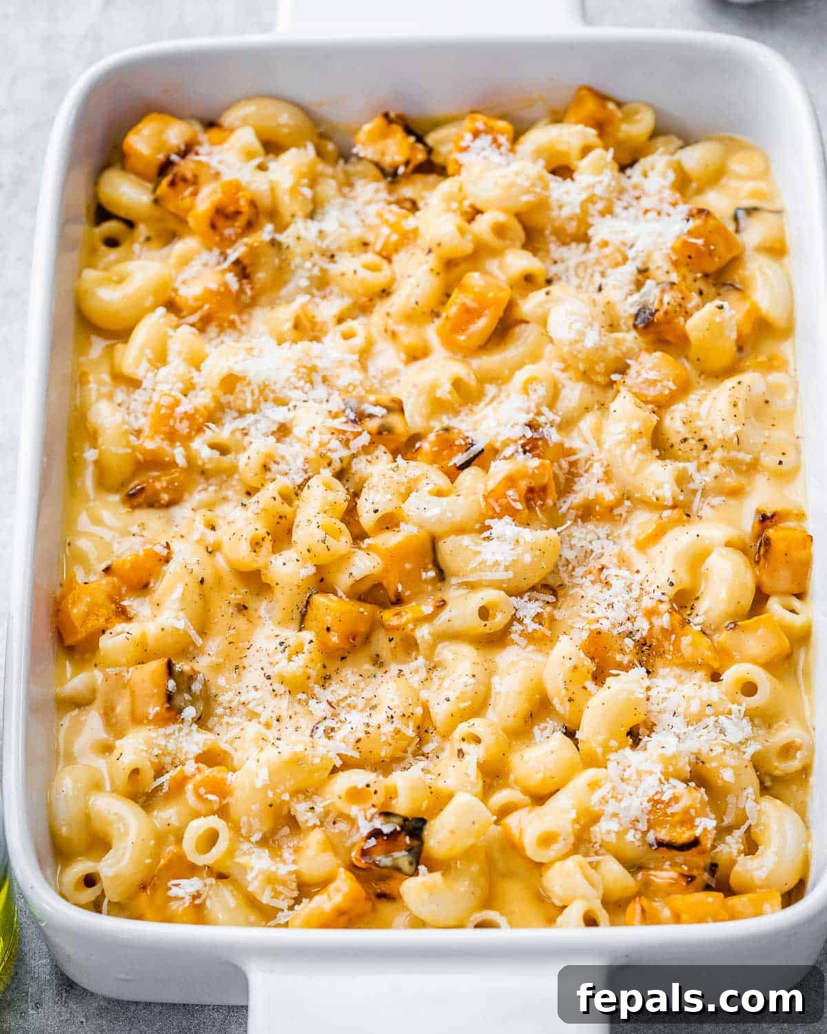 Velvety Butternut Mac and Cheese 13 a white dish with mac and cheese made with cheese and added butternut squash.