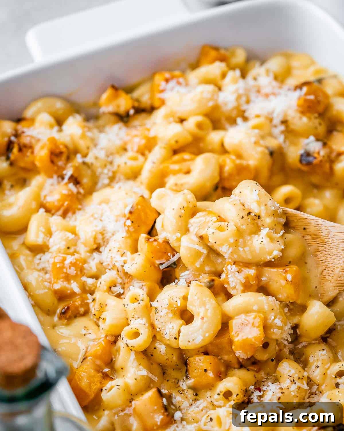 Velvety Butternut Mac and Cheese 14 Using a wooden spoon to serve macaroni and cheese with butternut squash.
