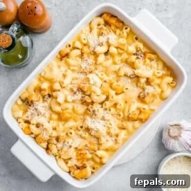 Velvety Butternut Mac and Cheese 3 A white dish with mac and cheese made with added roasted butternut squash.