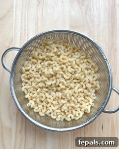 Velvety Butternut Mac and Cheese 5 pasta in a colander for butternut squash mac and cheese.
