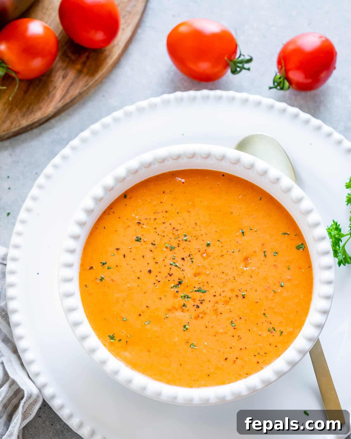 Smoked Tomato Bisque 11 A bowl full of rich, orange-hued creamy roasted tomato soup, inviting and delicious.