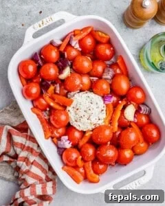 Smoked Tomato Bisque 15 Boursin cheese added to the middle of the tomatoes in a white dish.