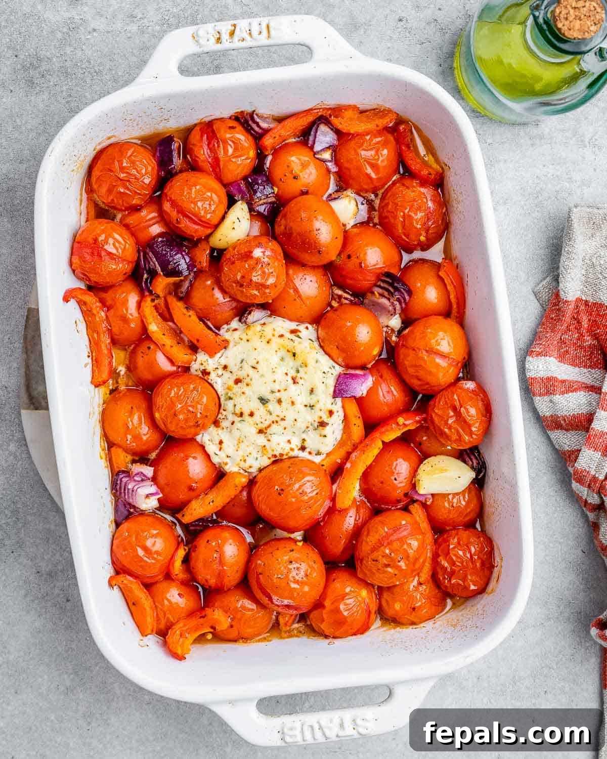 Smoked Tomato Bisque 7 Roasted tomatoes and Boursin cheese in a baking dish, bubbly and softened after baking.