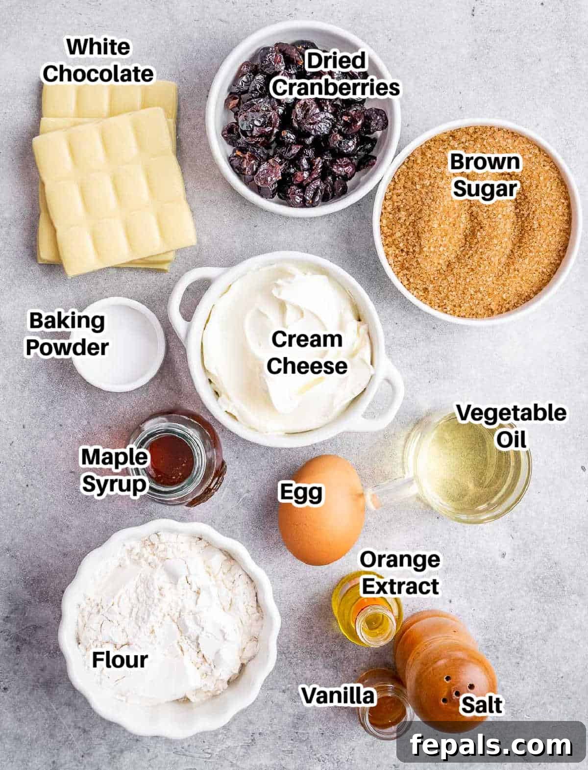 A vibrant flat lay of all the essential ingredients laid out for making cranberry bliss bars.