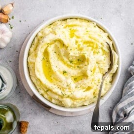 A small round bowl filled with creamy Boursin mashed potatoes, ready to be served and enjoyed.
