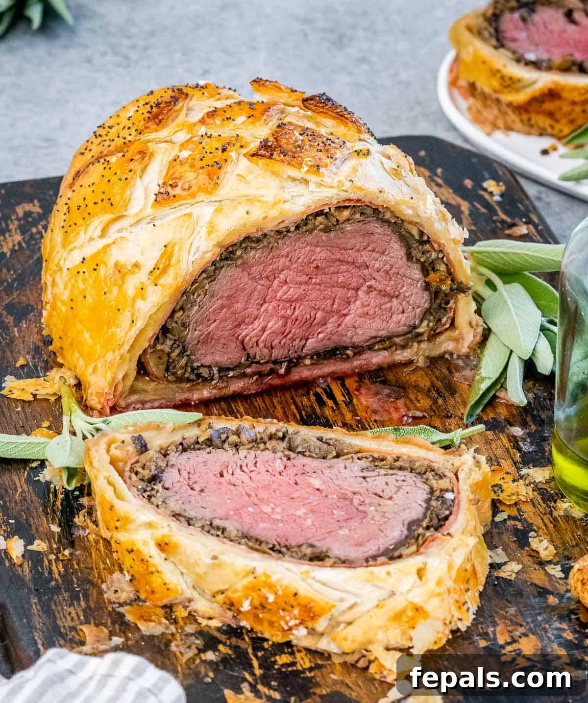 Regal Beef Wellington 2 A perfectly sliced Beef Wellington showcasing its layers, resting on a cutting board, ready to be served.