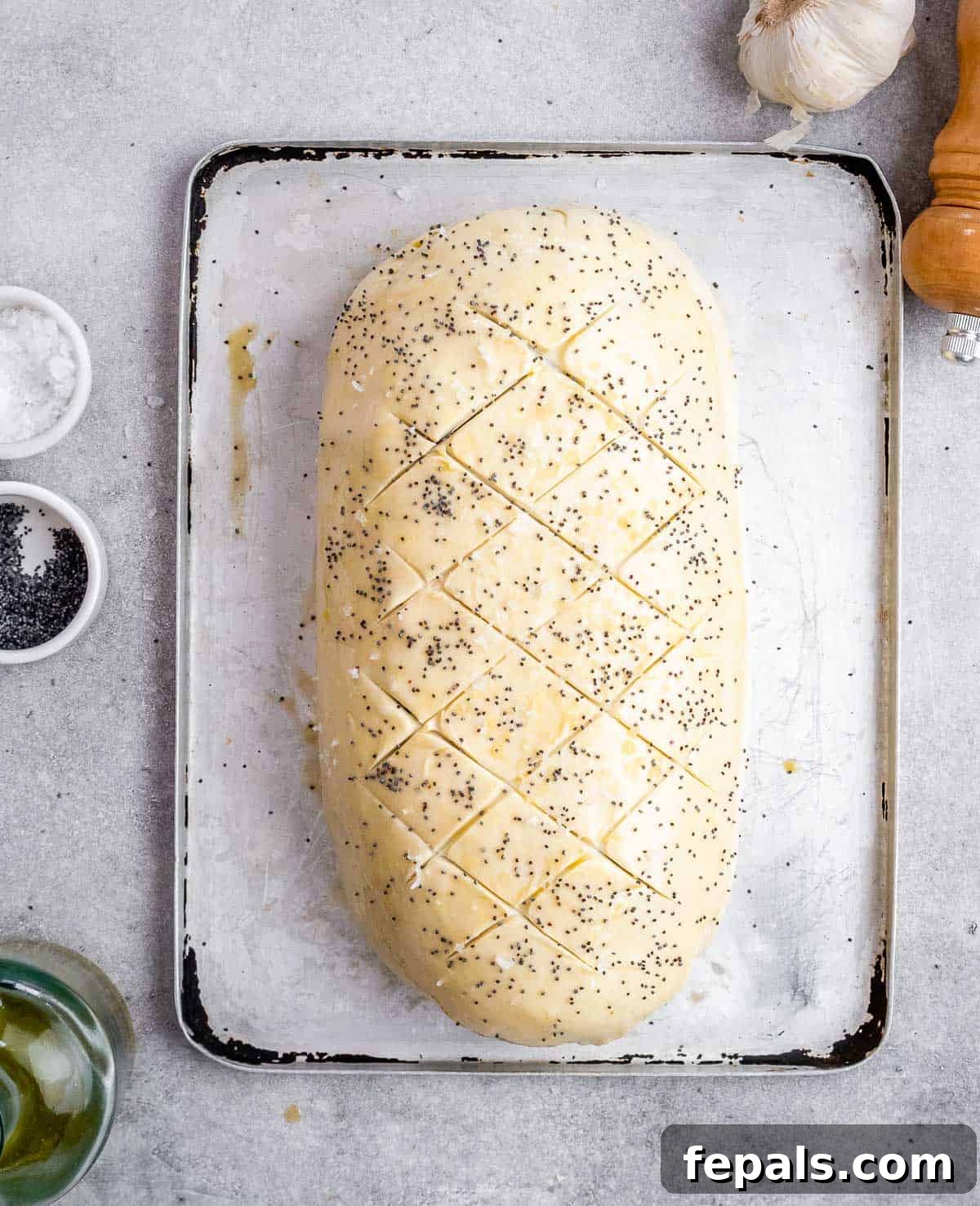 Regal Beef Wellington 7 The Beef Wellington, fully wrapped in puff pastry, is ready for baking on a sheet pan.
