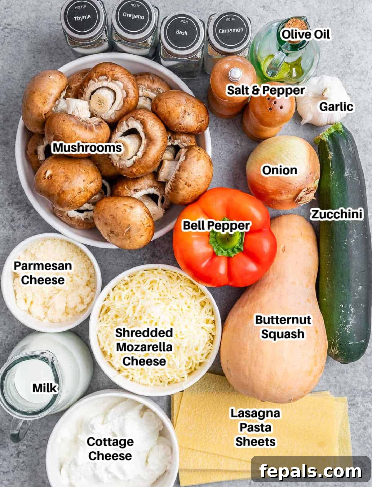 Velvety Butternut Squash Lasagna 3 A flat lay photograph showcasing all the fresh, wholesome ingredients for butternut squash lasagna, including a whole squash, various cheeses, colorful vegetables, and aromatic seasonings laid out on a rustic wooden board.