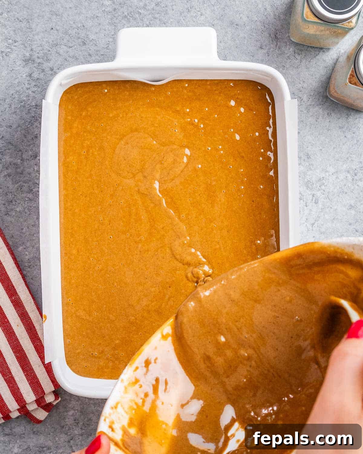 The batter is poured into a baking dish.