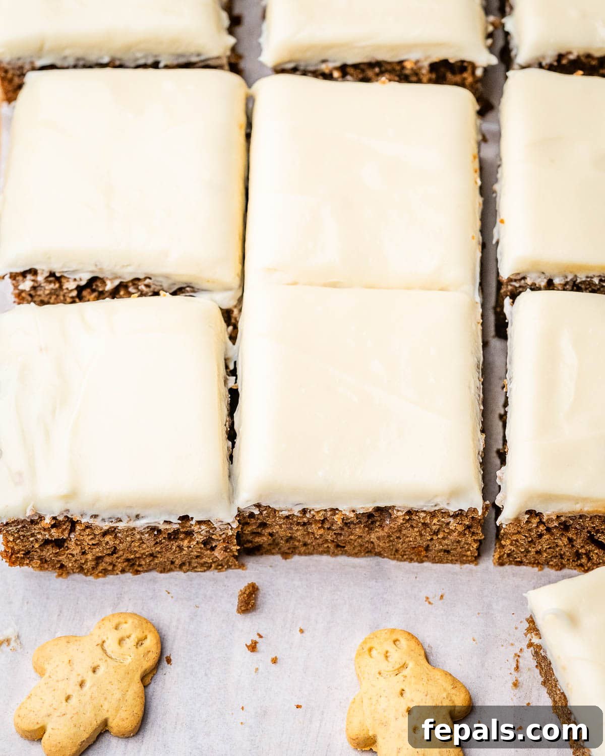 cake cut into squares topped with vanilla frosting.