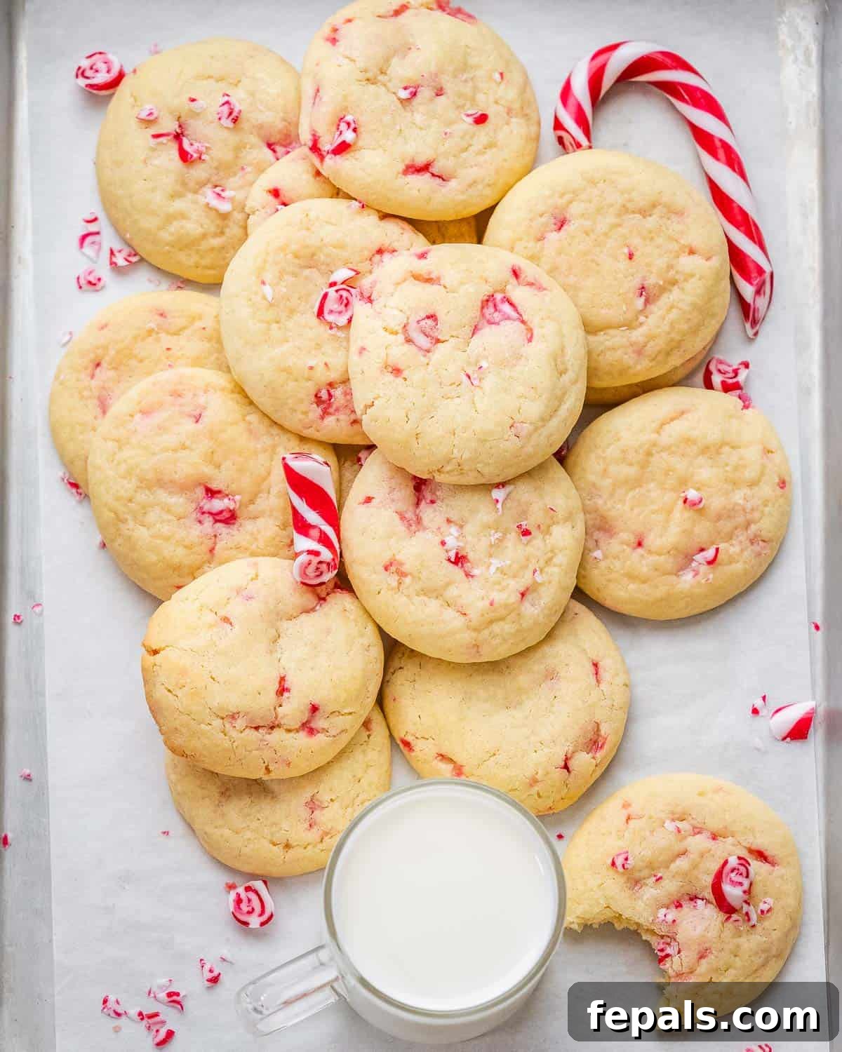 A sheet pan filled with freshly baked peppermint cookies, ready to be enjoyed with a glass of milk.