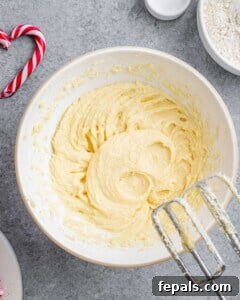 eggs and sugar whipped in a bowl with a mixer.