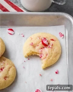 bite taken off a cookie on a sheet pan.