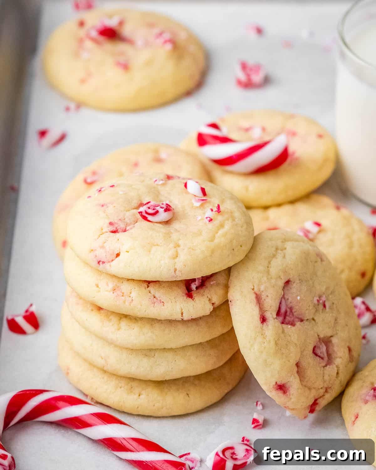A charming stack of warm peppermint cookies resting on a sheet pan, ready to be served or stored.