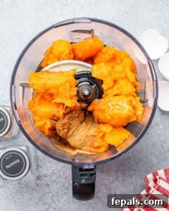 Roasted sweet potato in a food processor, ready to be blended for the pie filling.