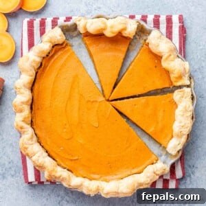 Sweet potato pie with several clean slices cut, showing the creamy orange filling and flaky crust.