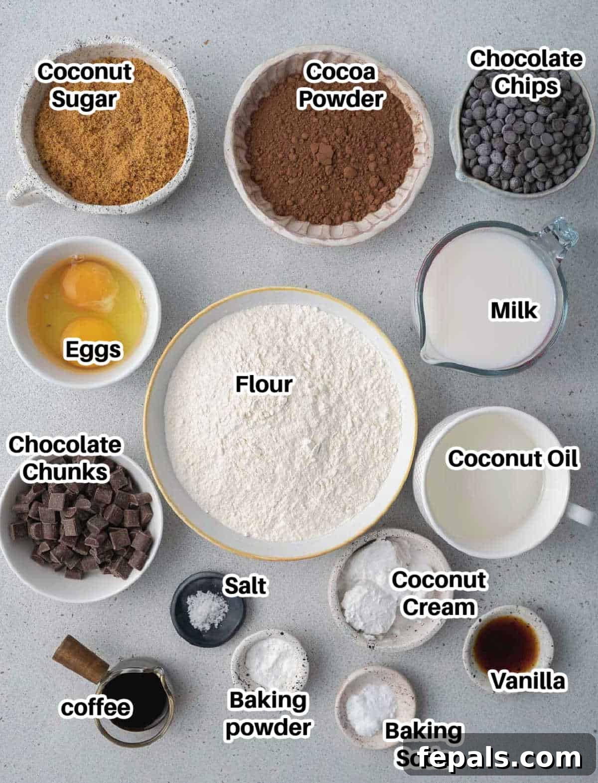 Olympian's Delight Chocolate Muffins 3 Various ingredients laid out for making the viral Olympic village chocolate muffins, including flour, sugar, eggs, and chocolate.