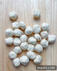 stuffed dough balls placed on a flat surface.