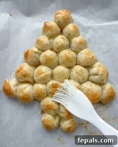 herbed oil is brushed over the baked cheeseballs.