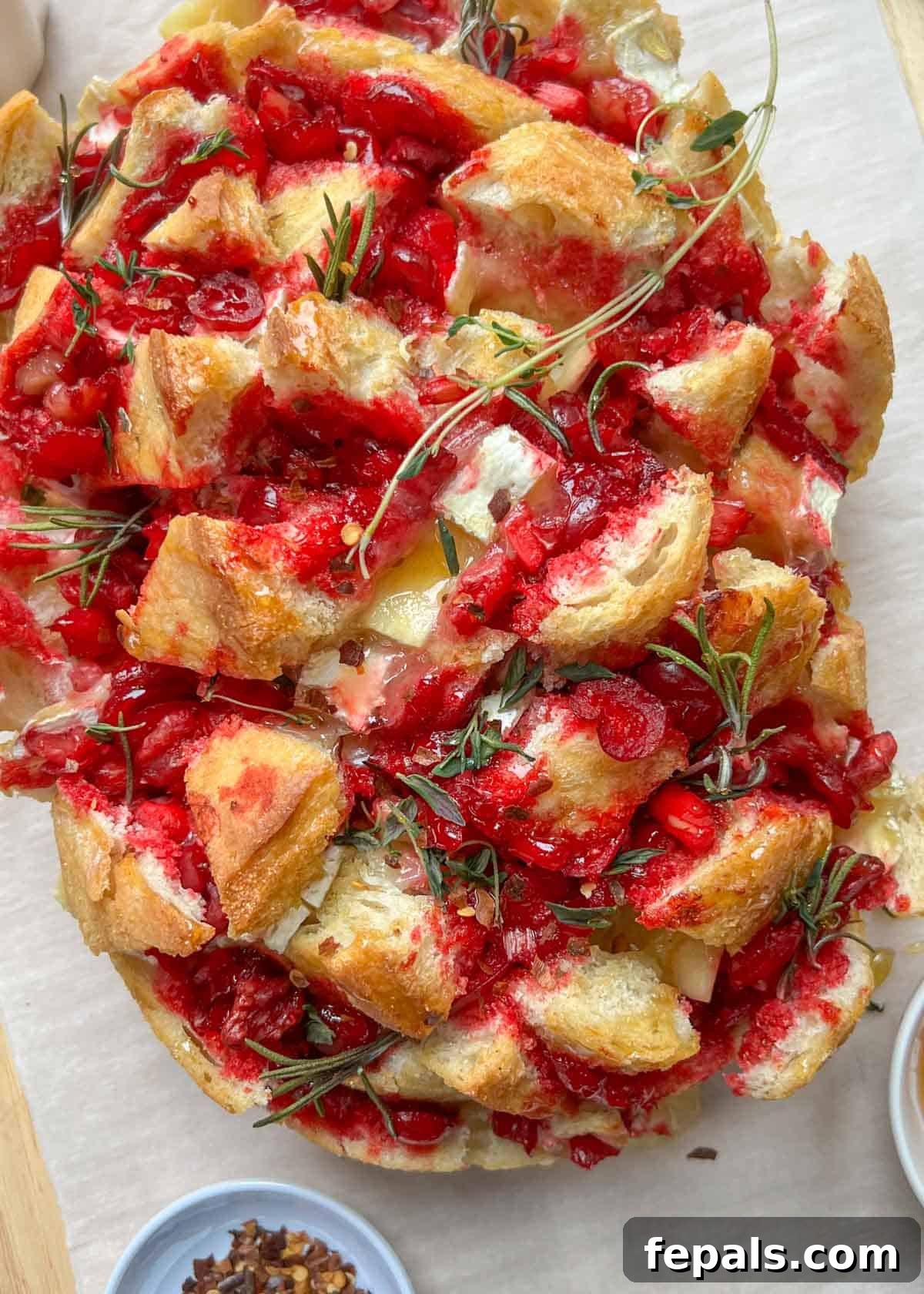 baked bread with cranberry sauce and brie cheese.