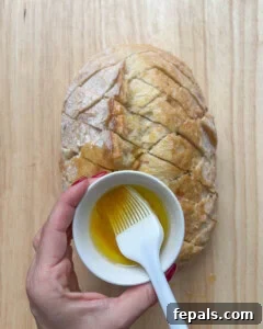 a bowl of oil over the bread and brush to rub oil on the bread.