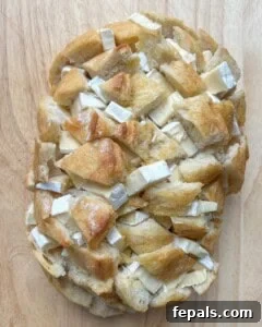 brie cheese added to slits of bread.